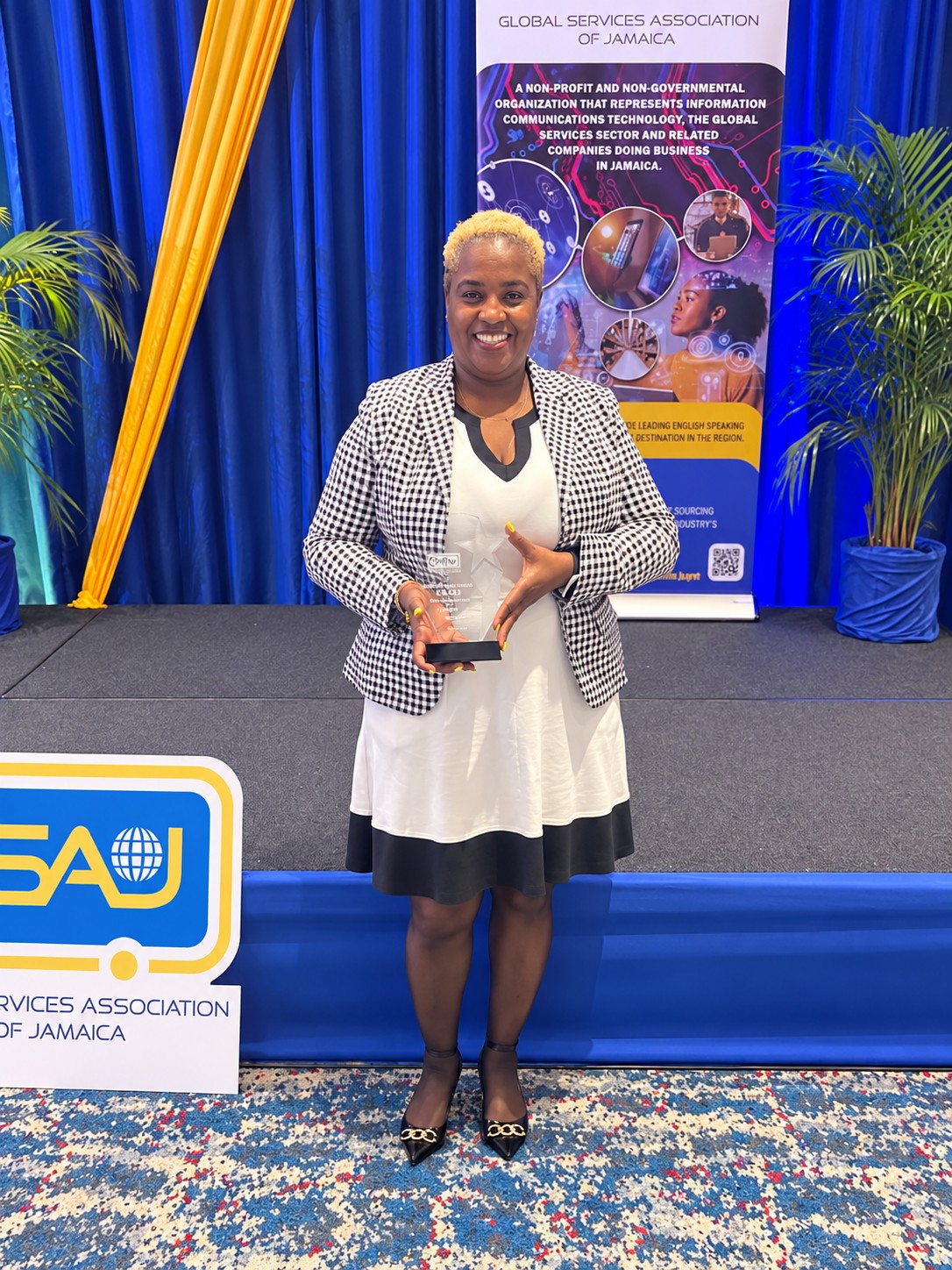 Ingrid Marshall holding an award at an industry event